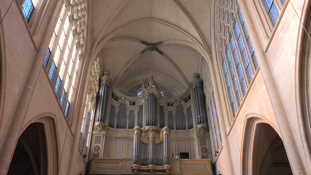 Low angle shot of pipe organ in the interior of a roman catholic church of Saint-Germain-l'Auxerrois in Paris, France at daytime