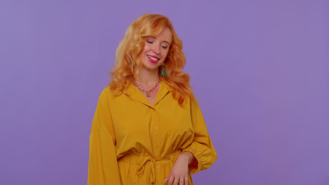 Redhead girl looking approvingly at camera showing ok gesture like sign positive something good