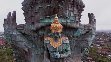 aerial footage shows the garuda wisnu kencana monument towering above southern bali, crafted with intricate detail and standing as a symbol of balinese spirituality and national pride