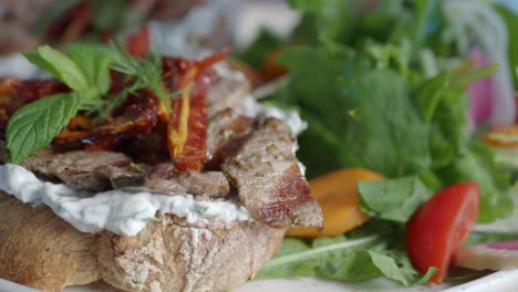 delicious greek bruschetta with grilled meat and salad