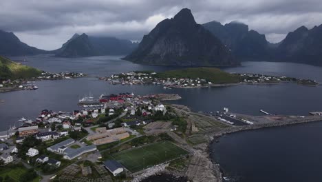 Sakrisoy,-Olenilsoya,-and-Hamnoy-islands-against-Reinefjorden-fjord-and-steep-mountains-cliffs-in-Moskenes-municipality-in-Nordland-county-in-Norway---side-dolly