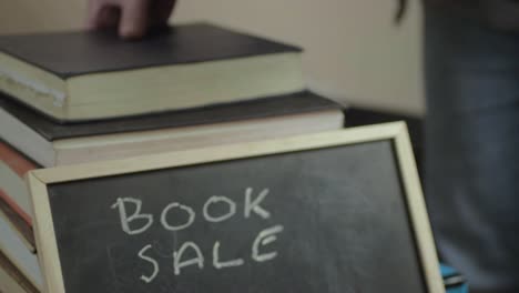 looking through a collection of books at a book sale