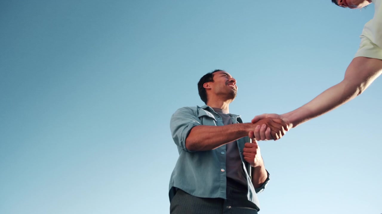 Professional Man Greeting Colleague with Handshake Outdoors