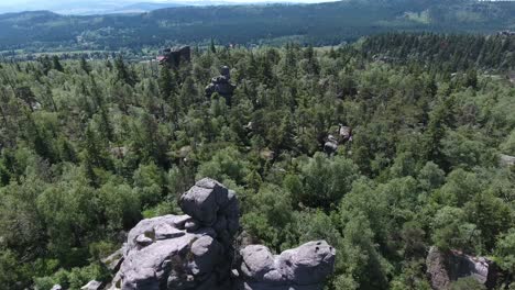 Aerial-Shot-Of-Sandstone-Rocks-In-The-Middle-Of-Dense-Mountain-Forest