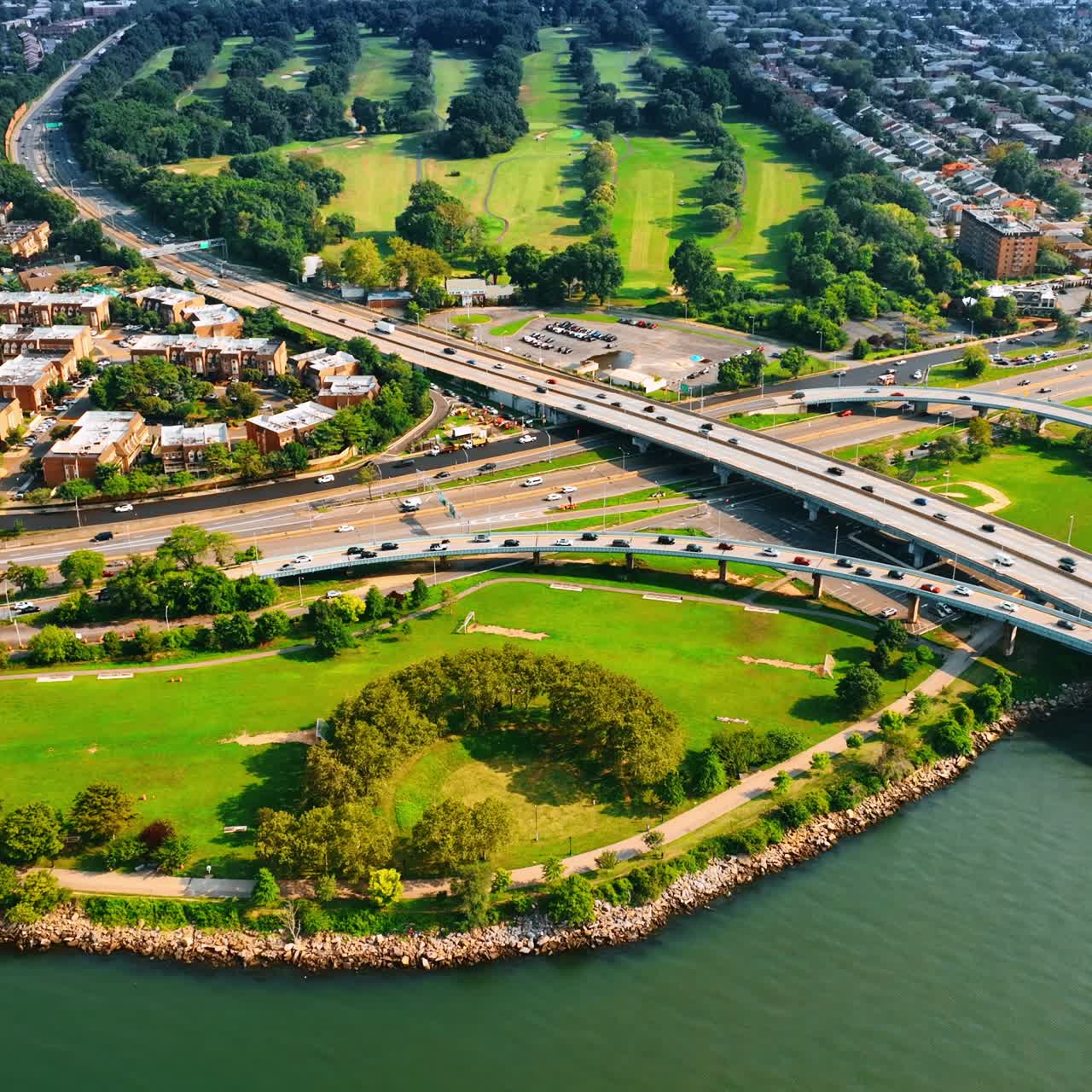 Bright lively cityscape of Bay Terrace, Queens, New York. Top view on the land from above the East River near the Throgs Neck Bridge