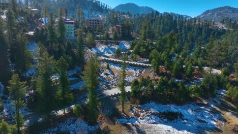 ascending ariel footage of drone looking over hotel in malam jabba sawat valley with blue sky