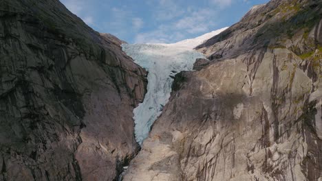briksdalsbreen glacier in norway, briksdal, scandinavia with thick ice. epic mountain nature aerial.