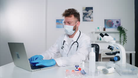 doctor working on a laptop in a lab