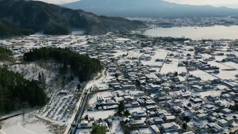 stunning tilt up reveal over mount fuji landscape covered in snow at mount fuji