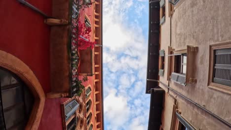 walking through verona's old town, seeing the sky as a small stripe between historic buildings.