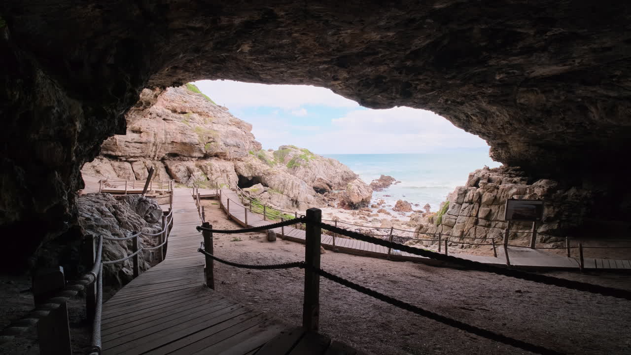 Wooden walkway boardwalk through historic Klipgat Cave, De Kelders, South Africa