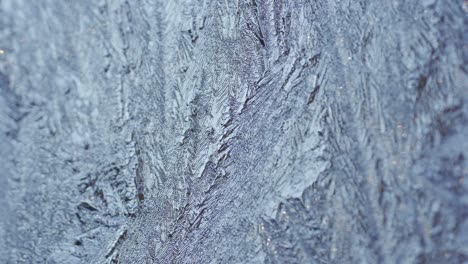 macro shot of snowflakes on glass, frozen crystal icicles in winter