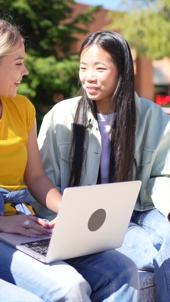 Students Collaborating on a Laptop Outdoors