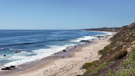 crashing waves on newport ca beach on a beautiful clear sunny day