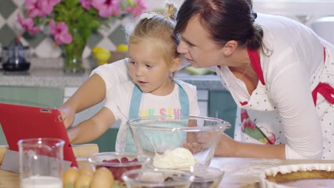 mother and daughter checking a baking recipe