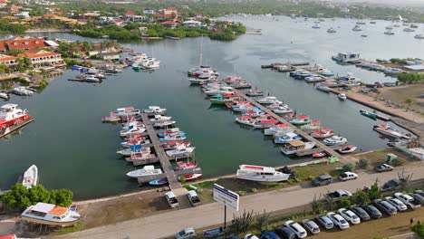 fishing boats lined up at harbor of spanish waters, curacao, aerial overview