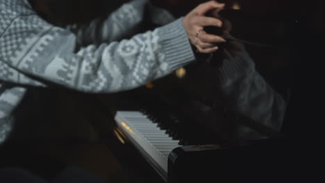 woman playing piano in the dark