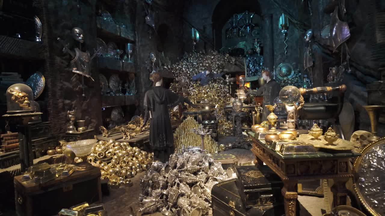 A fake treasure haul of gold and valuables and mannequins. Interior, dolly.