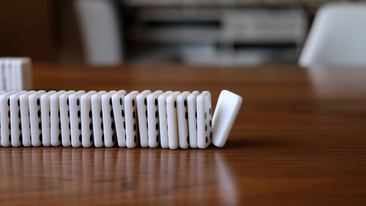 Satisfying Domino Cascade On Wooden Table Closeup Of White Dominoes Lined Across Polished Wood Surface Single