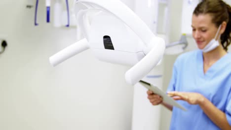 dental assistant using digital tablet