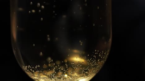 relaxing observation of trapped bubbles escaping the compounds of a wine glass - close up slow motion shot