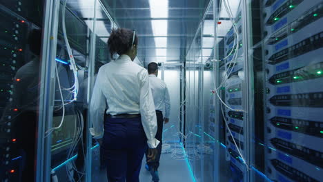 it technicians inspecting server racks in data center