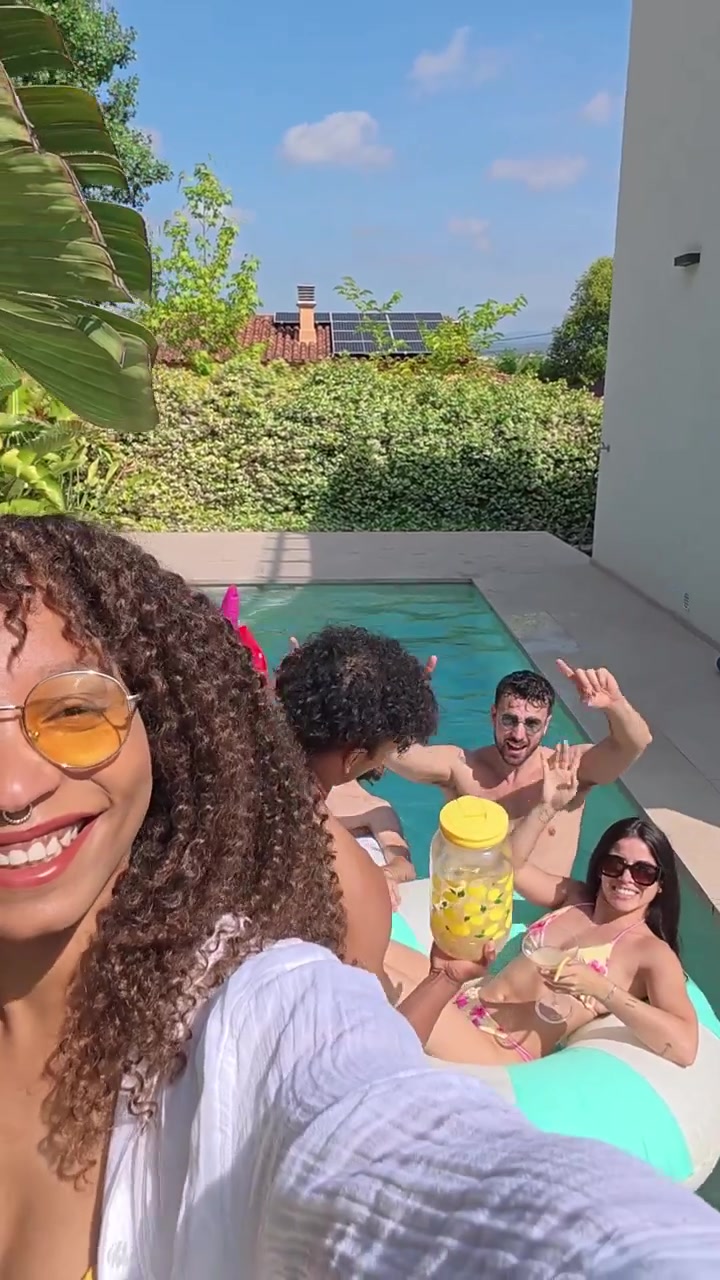 Gruppo di amici che si divertono a una festa in piscina soleggiata
