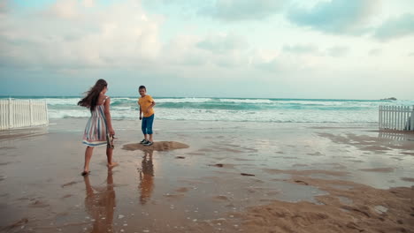 niños felices relajándose en la playa de arena. hermano y hermana jugando en la orilla del mar.
