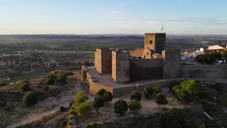 Aerial-orbiting-around-Monsaraz-Castle-at-sunset,-Portugal