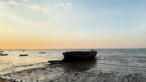 wrecked boat at sunset on pattaya beach