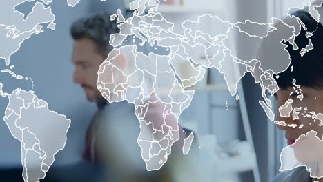 animation of world map over diverse colleagues working in office