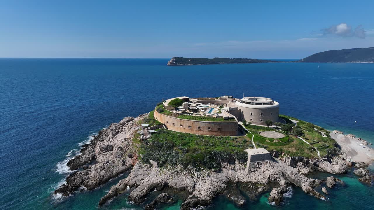 Old fortress resort on Mamula Island surrounded by clear blue sea, sunny day vibe