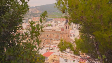 View-of-the-historic-city-of-Sagunto,-Valencia-in-Spain-framed-by-greenery