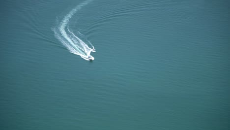 view from a hostel on the 66th floor of a building in dubai of two people water skiing behind a boat in the ocean