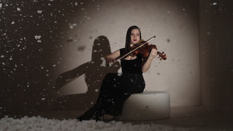 woman playing violin in a winter scene