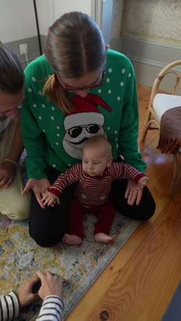 family celebrating christmas with baby