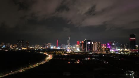 a stunning aerial view of ho chi minh city skyline at night, featuring iconic skyscrapers