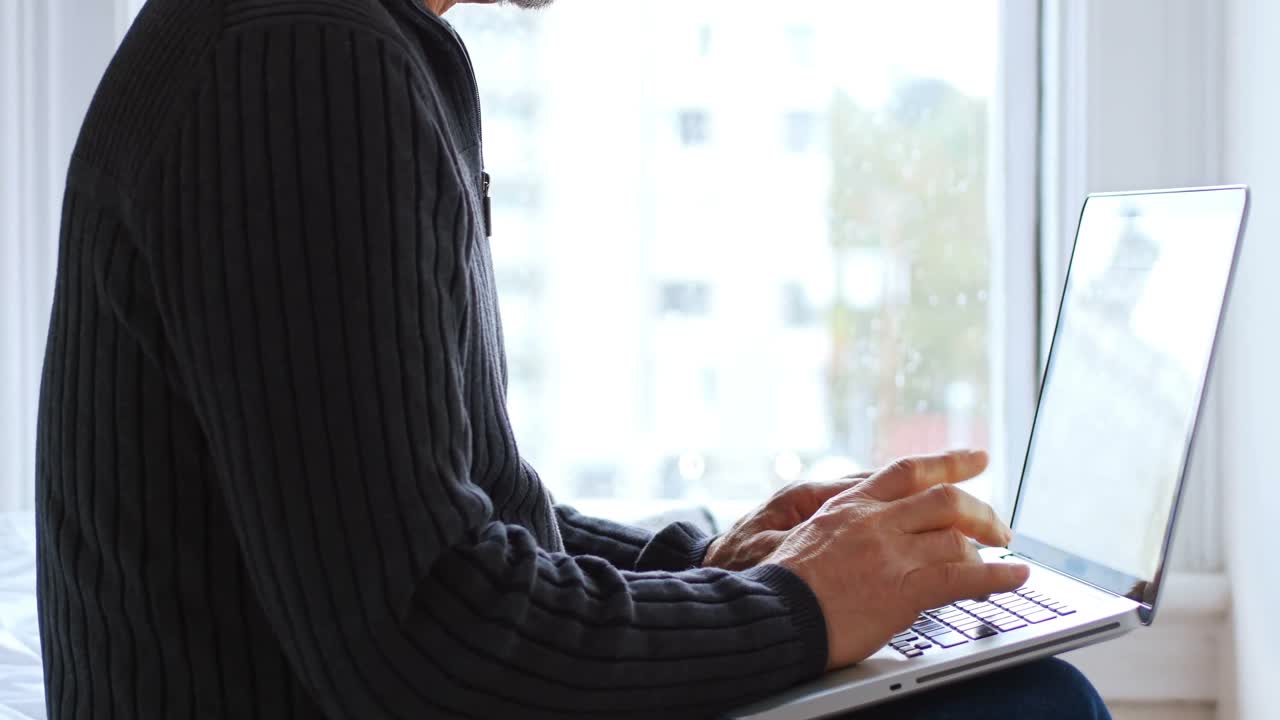 Man using laptop in bedroom 4k