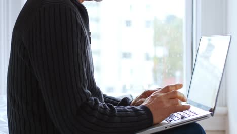 man using laptop in bedroom 4k