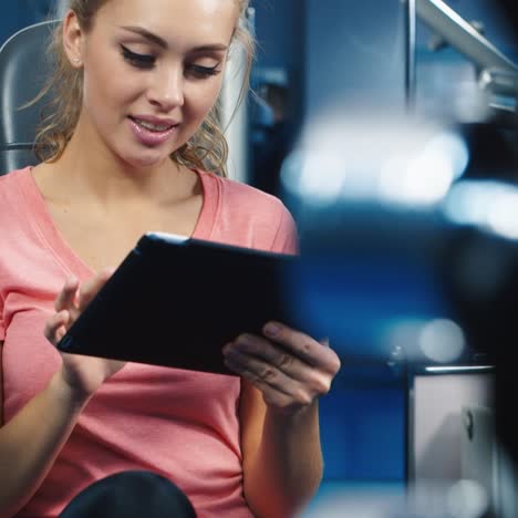 portrait of a young woman using a tablet during training