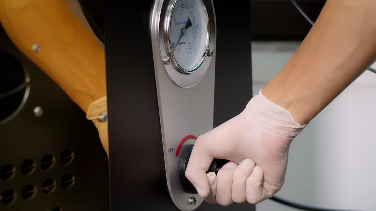Hand On Control Panel To Start Work Of Coffee Roaster