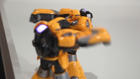 Yellow robots boxing. Close up of battle robot. Two robot fight