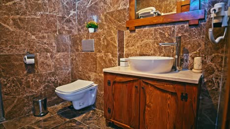 The-interior-of-a-modern-hotel-bathroom-clad-in-brown-marble