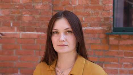 woman with an attractive look looking thoughtfully at the camera in a bad mood