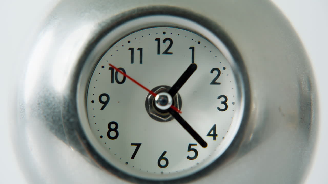 Time indicator rotating hands at white background closeup. Clock displaying