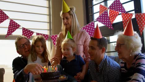 grandfather lighting candles in living room at home 4k