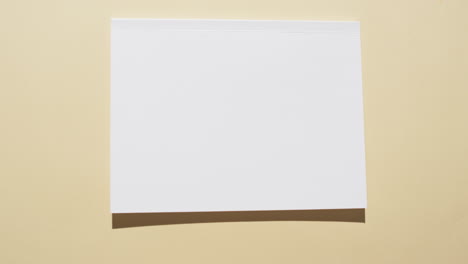 video of book with blank white pages and copy space on yellow background