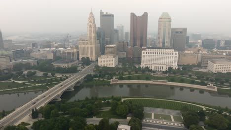 aerial view of columbus ohio city skyline on a foggy smoky day - approaching city
