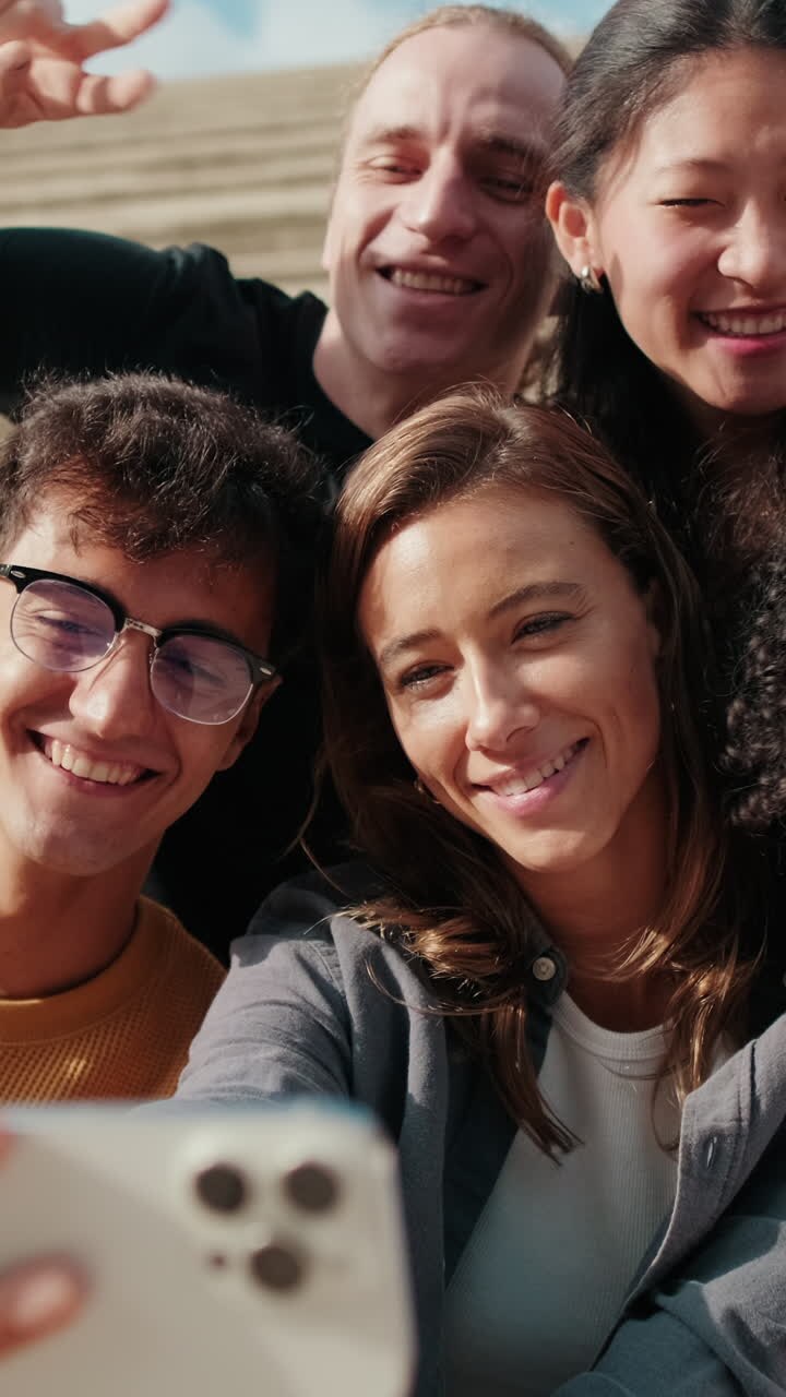 Group of joyfull happy students taking a selfie or video with their phone