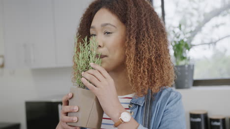 Young-African-American-woman-smells-fresh-herbs-at-home